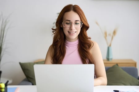 Woman sitting with smiling computer 